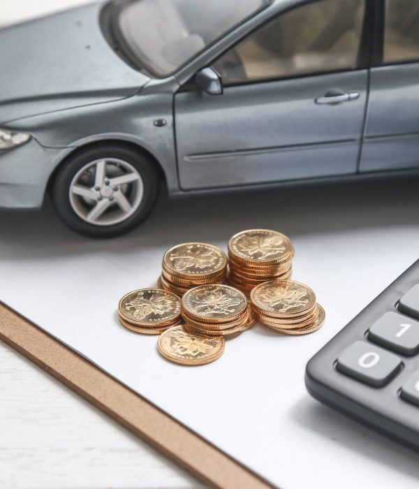 car model,calculator and coins on white table